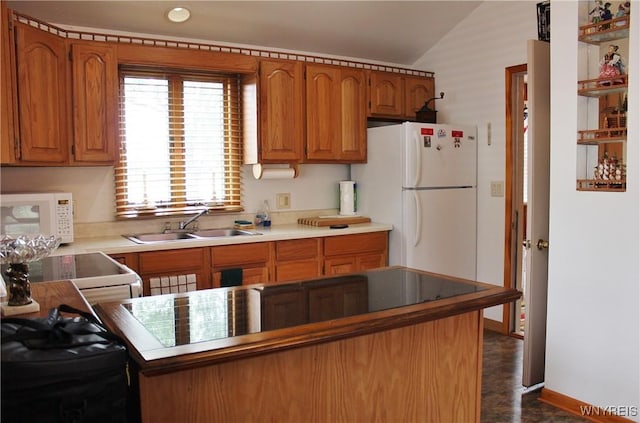 5436 Java Lake Rd, Java, NY 14009 - kitchen featuring white appliances, vaulted ceiling, brown cabinets, and recessed lighting