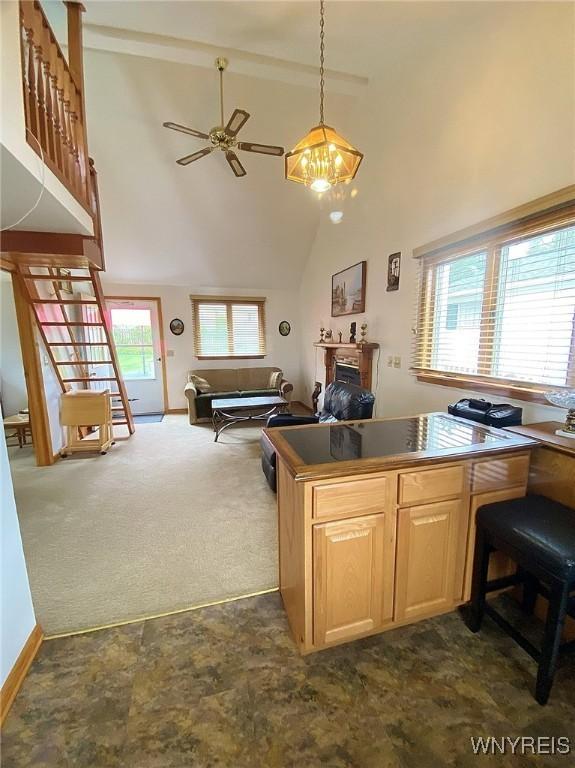 5436 Java Lake Rd, Java, NY 14009 - kitchen with a fireplace, light brown cabinets, ceiling fan, dark carpet, and high vaulted ceiling