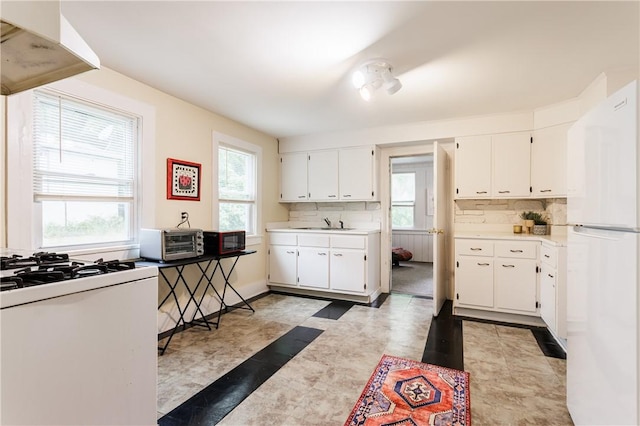 72 Weld St, Rochester, NY 14605 - kitchen with white appliances, range hood, white cabinetry, and light countertops
