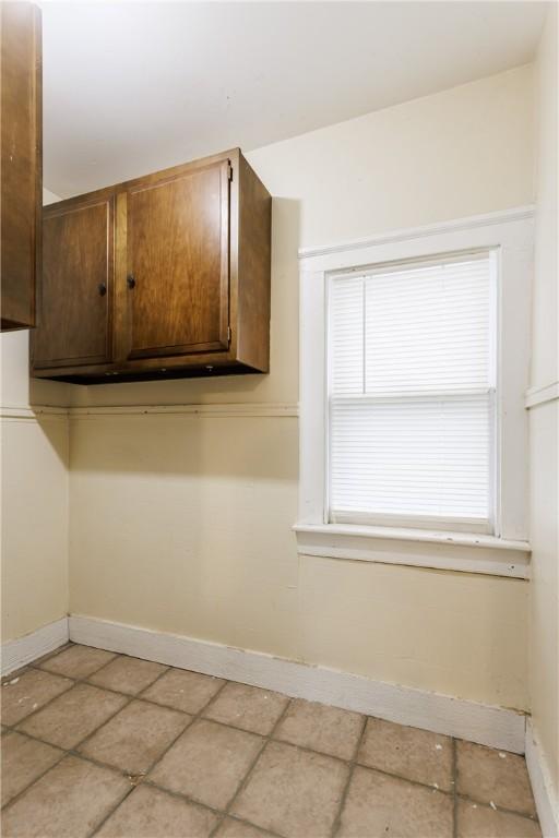 72 Weld St, Rochester, NY 14605 - kitchen with baseboards and dark brown cabinets