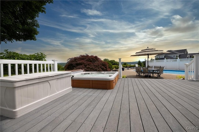 2516 W Lake Rd, Skaneateles, NY 13152 - deck at dusk with an outdoor hot tub, a pool, and outdoor dining area