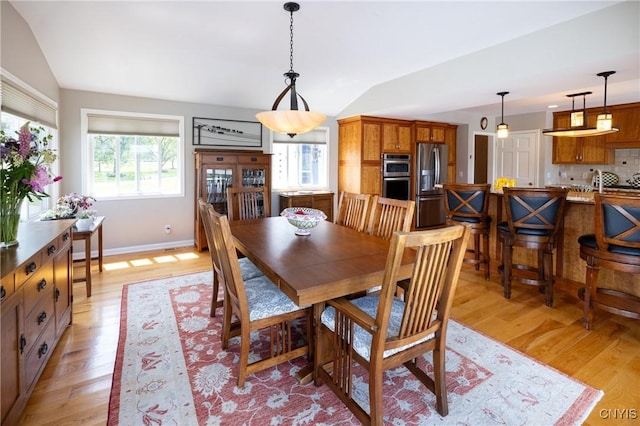 2516 W Lake Rd, Skaneateles, NY 13152 - dining space featuring lofted ceiling and light wood-style flooring