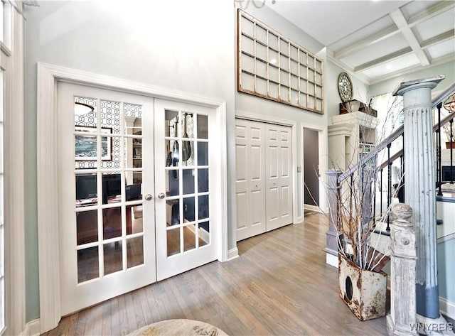 1469 Hopkins Rd, Amherst, NY 14221 - entryway featuring french doors, decorative columns, beamed ceiling, coffered ceiling, and wood finished floors