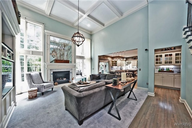 1469 Hopkins Rd, Amherst, NY 14221 - living room with a towering ceiling, a chandelier, dark wood-style floors, coffered ceiling, and a high end fireplace