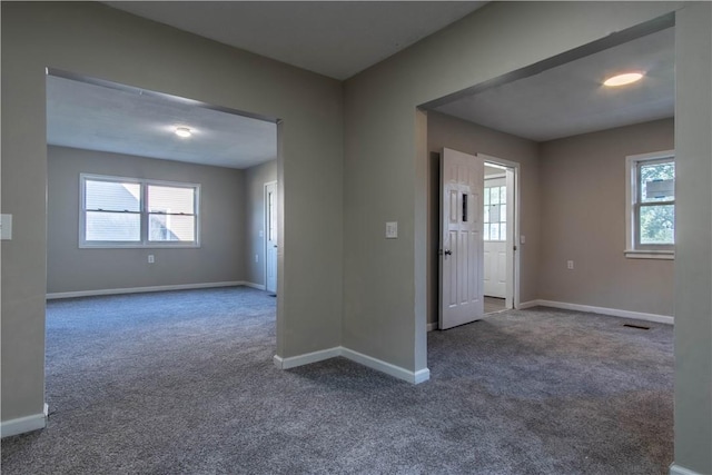 11 Grove St, Adams, NY 13605 - unfurnished room featuring dark carpet and plenty of natural light