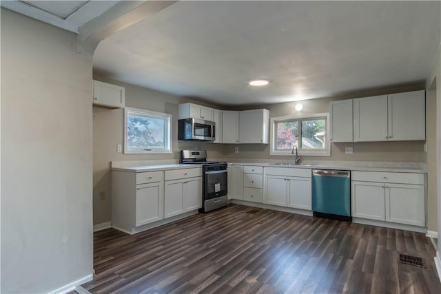 11 Grove St, Adams, NY 13605 - kitchen featuring stainless steel appliances, dark wood-type flooring, white cabinetry, and light countertops