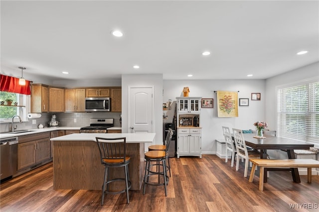 720 N Star Rd, Elma, NY 14052 - kitchen with appliances with stainless steel finishes, light countertops, dark wood-style floors, backsplash, and a kitchen island