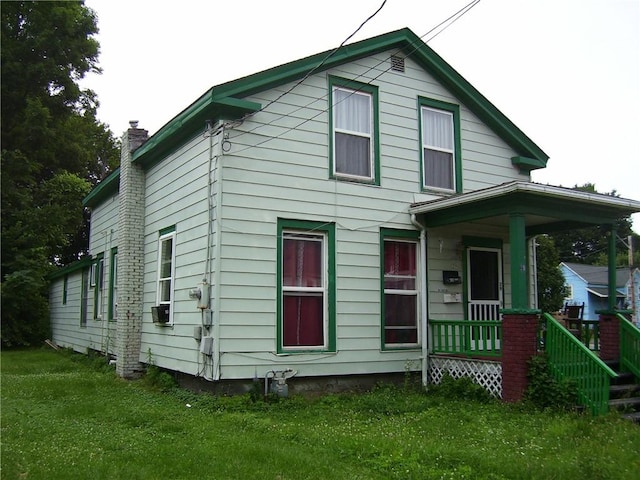 29 Mitchell St, Norwich, NY 13815 - view of front of home featuring covered porch, a front yard, and a chimney