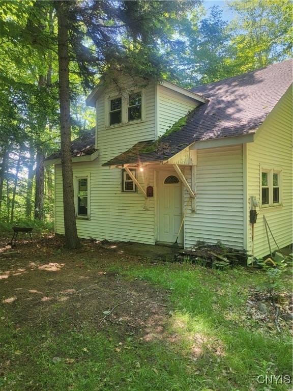 182 Seneca Rd, Webb, NY 13420 - rear view of property featuring a shingled roof