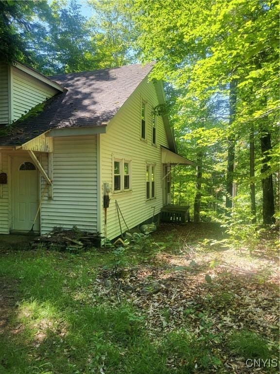 182 Seneca Rd, Webb, NY 13420 - view of side of home featuring a shingled roof
