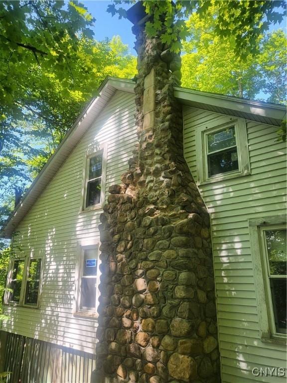 182 Seneca Rd, Webb, NY 13420 - view of side of home featuring a chimney