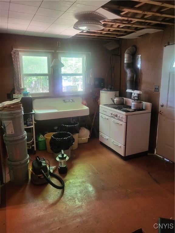 182 Seneca Rd, Webb, NY 13420 - kitchen featuring white range with gas cooktop and water heater