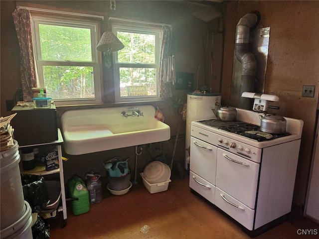 182 Seneca Rd, Webb, NY 13420 - kitchen with water heater, white cabinets, and white range with gas cooktop