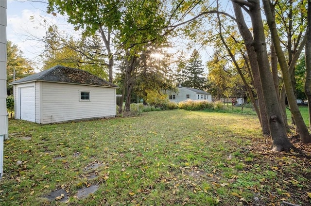 23 Peacock St, Auburn, NY 13021 - view of grassy yard with an outdoor structure and a garage