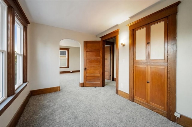 23 Peacock St, Auburn, NY 13021 - unfurnished room featuring arched walkways and carpet flooring