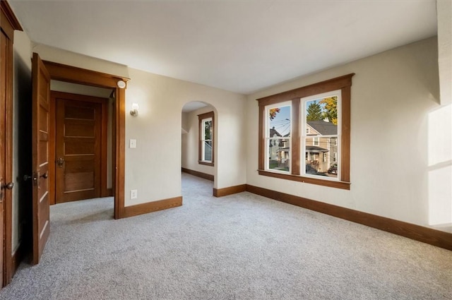 23 Peacock St, Auburn, NY 13021 - carpeted empty room featuring arched walkways and baseboards