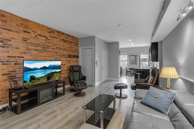 65 Whitney Pl Unit 5, Buffalo, NY 14201 - living area featuring brick wall and light wood-style floors