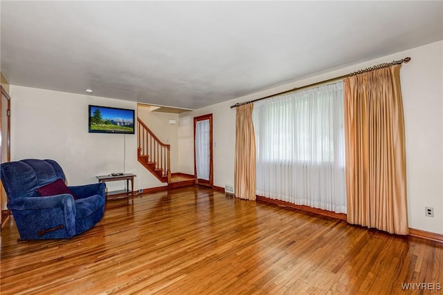 2104 Walnut Ave, Niagara Falls, NY 14301 - unfurnished living room with light wood-style floors and stairway