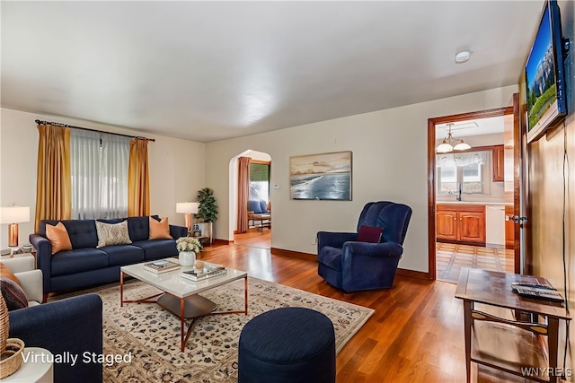 2104 Walnut Ave, Niagara Falls, NY 14301 - living area featuring arched walkways and light wood-style floors