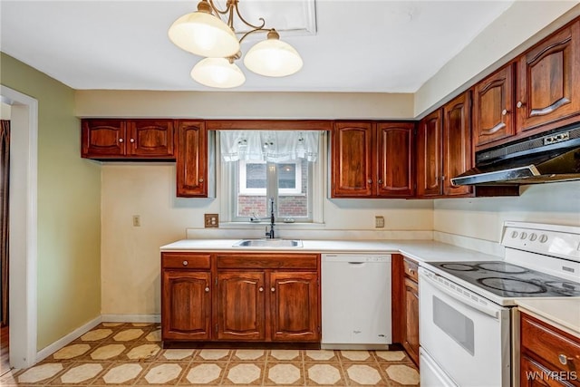 2104 Walnut Ave, Niagara Falls, NY 14301 - kitchen with white appliances, under cabinet range hood, light countertops, light floors, and a chandelier