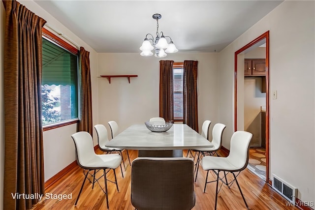 2104 Walnut Ave, Niagara Falls, NY 14301 - dining area featuring light wood finished floors and a chandelier