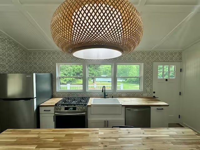 1737 Tupper Hill Rd, Franklin, NY 13775 - kitchen with appliances with stainless steel finishes, butcher block countertops, wallpapered walls, and wood finished floors
