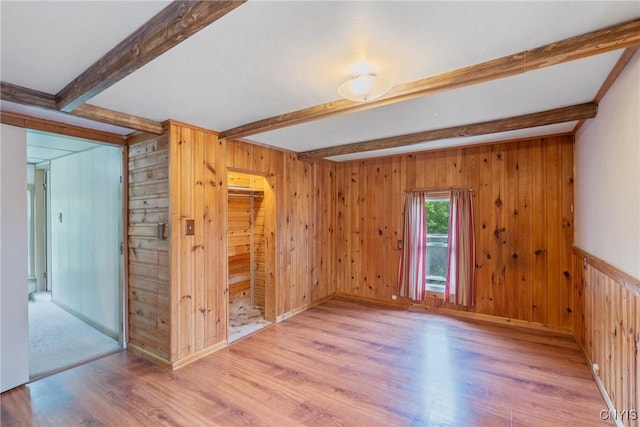 388 Sutton Rd, Schroeppel, NY 13132 - spare room with beam ceiling, light wood finished floors, and wood walls