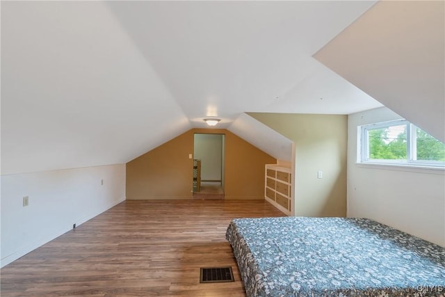 388 Sutton Rd, Schroeppel, NY 13132 - bedroom featuring wood finished floors and lofted ceiling