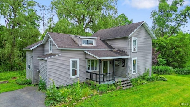 388 Sutton Rd, Schroeppel, NY 13132 - view of front of house with covered porch, a shingled roof, and a front lawn