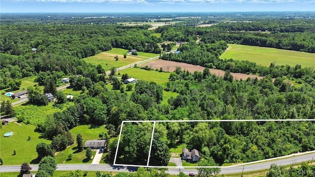 388 Sutton Rd, Schroeppel, NY 13132 - aerial view of property and surrounding area featuring property parcel outlined and a heavily wooded area