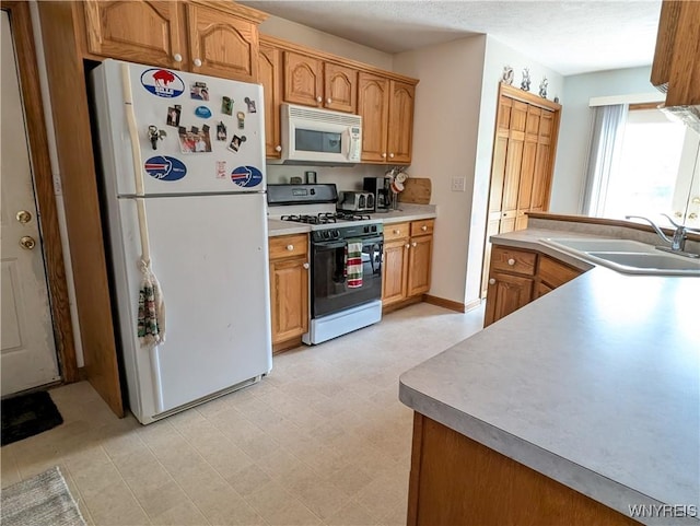 11030 Roosevelt Hwy, Yates, NY 14098 - kitchen featuring white appliances, light countertops, and brown cabinetry