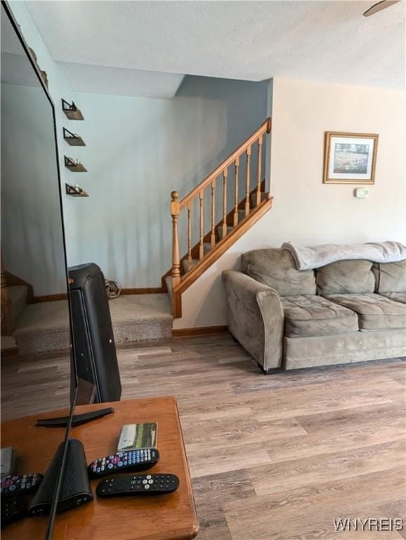 11030 Roosevelt Hwy, Yates, NY 14098 - living area featuring stairway, wood finished floors, ceiling fan, and a textured ceiling