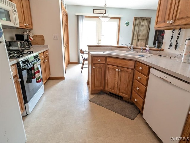 11030 Roosevelt Hwy, Yates, NY 14098 - kitchen featuring white appliances, a peninsula, light countertops, and brown cabinets