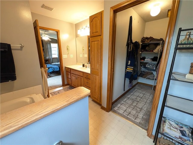 11030 Roosevelt Hwy, Yates, NY 14098 - ensuite bathroom with vanity, ceiling fan, a tub to relax in, and a closet