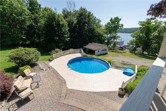 5343 Cedarwood Ln, Conesus, NY 14435 - outdoor pool with a patio area, a water view, an outdoor structure, and a lawn