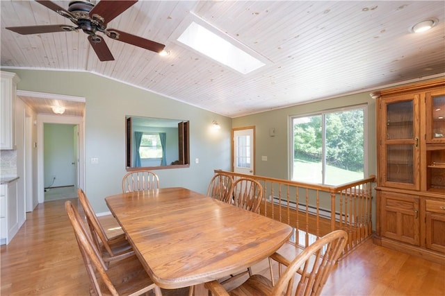 5343 Cedarwood Ln, Conesus, NY 14435 - dining space featuring a baseboard heating unit, wood ceiling, light wood-style flooring, vaulted ceiling, and a skylight
