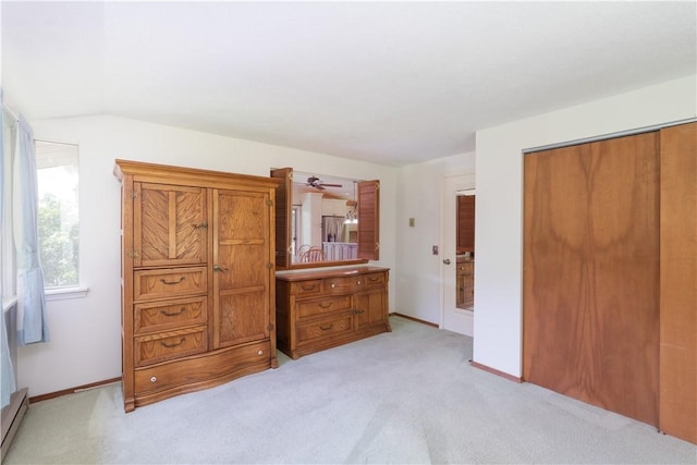 5343 Cedarwood Ln, Conesus, NY 14435 - bedroom featuring a closet, light carpet, vaulted ceiling, and a baseboard heating unit