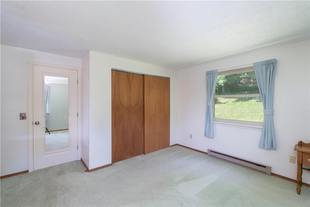 5343 Cedarwood Ln, Conesus, NY 14435 - unfurnished bedroom with baseboard heating, light colored carpet, and a closet