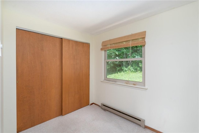 5343 Cedarwood Ln, Conesus, NY 14435 - unfurnished bedroom with baseboard heating, a closet, and carpet
