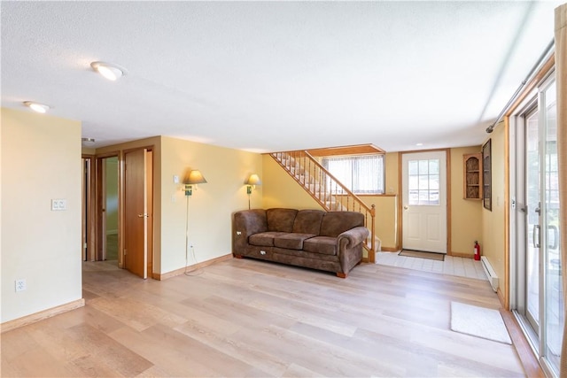 5343 Cedarwood Ln, Conesus, NY 14435 - living area with light wood finished floors, baseboard heating, and stairs