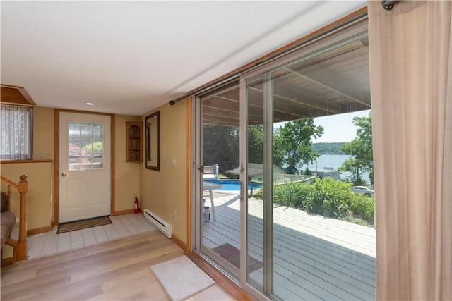 5343 Cedarwood Ln, Conesus, NY 14435 - doorway to outside featuring a baseboard heating unit, light wood finished floors, and a water view