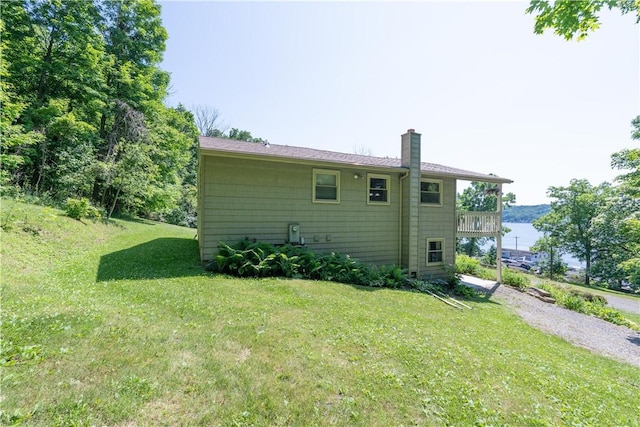 5343 Cedarwood Ln, Conesus, NY 14435 - back of property featuring a chimney, a yard, and a balcony