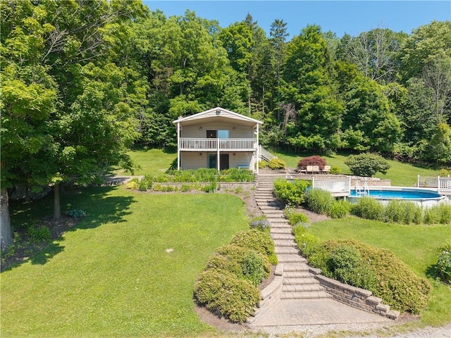 5343 Cedarwood Ln, Conesus, NY 14435 - view of front of house featuring a front lawn, an outdoor pool, stairway, and a wooded view