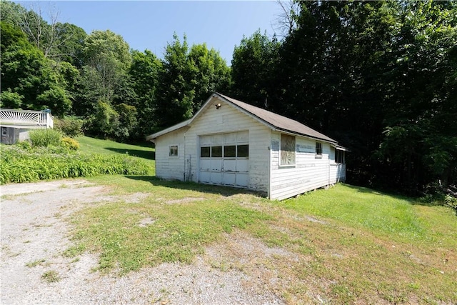 5343 Cedarwood Ln, Conesus, NY 14435 - view of home's exterior featuring a garage, an outbuilding, and a lawn