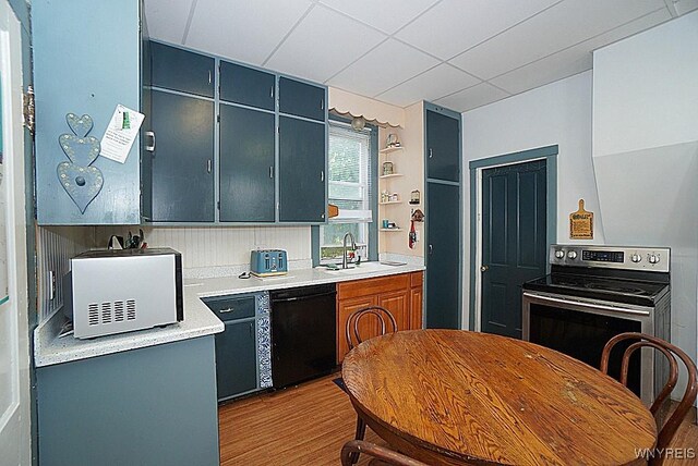 57 Christiana St, North Tonawanda, NY 14120 - kitchen featuring black dishwasher, wood finished floors, stainless steel electric stove, light countertops, and open shelves