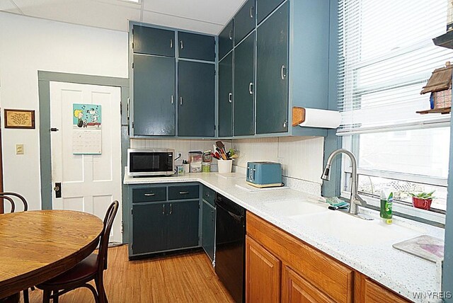 57 Christiana St, North Tonawanda, NY 14120 - kitchen featuring dishwasher, stainless steel microwave, light wood finished floors, and tasteful backsplash
