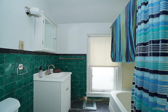 57 Christiana St, North Tonawanda, NY 14120 - bathroom featuring vanity, tile walls, and wainscoting