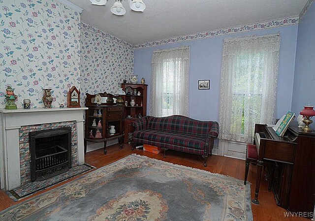 57 Christiana St, North Tonawanda, NY 14120 - living room with wood finished floors, plenty of natural light, ornamental molding, vaulted ceiling, and a textured ceiling