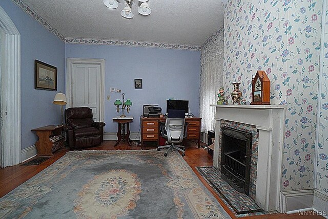 57 Christiana St, North Tonawanda, NY 14120 - office featuring wood finished floors, a fireplace with flush hearth, and a textured ceiling