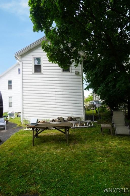 57 Christiana St, North Tonawanda, NY 14120 - view of side of home featuring a yard